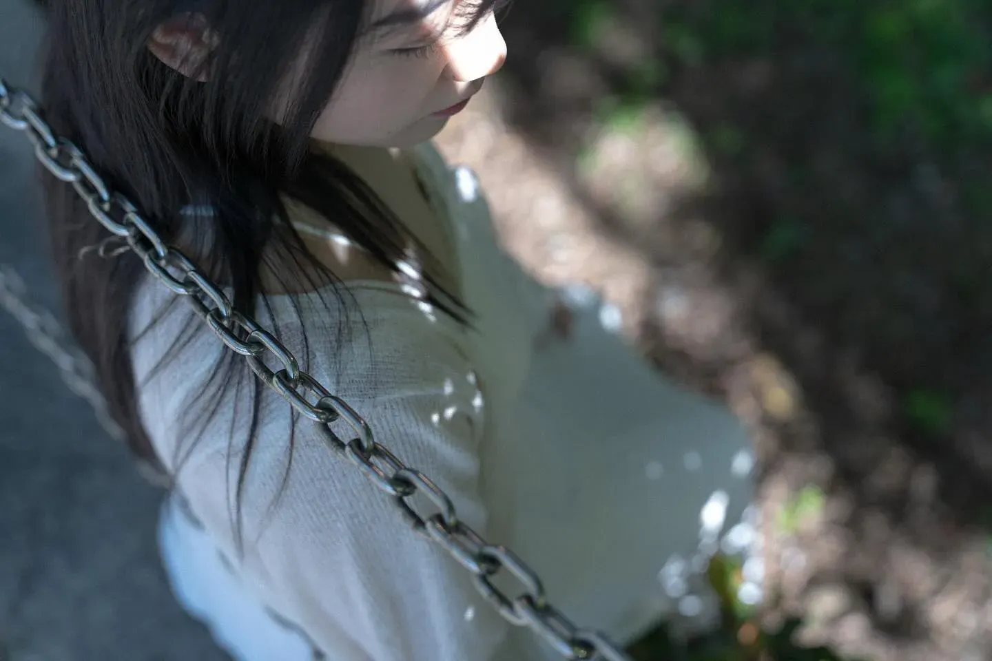 A figure seen between swing ropes